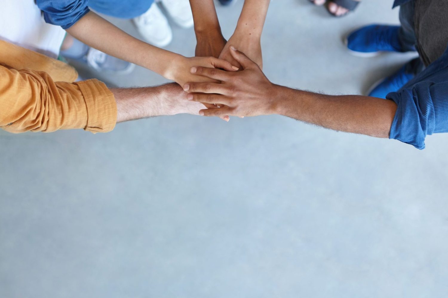Friendship, partnership, togetherness, collaboration concept. Group of international friends stacking their hands expressing their friendship, agreement and support. People piling their hands Friendship, partnership, togetherness, collaboration concept. Group of international friends stacking their hands expressing their friendship, agreement and support. People piling their hands